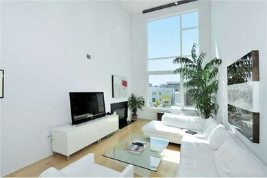 The living room is complete with motorized window shade and ambient fireplace!