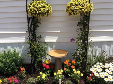 Pretty Perennial Garden with trellis and birdbath