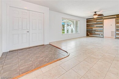 Tiled foyer entrance with ceiling fan
