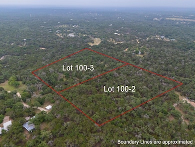 View of property location with a heavily wooded a