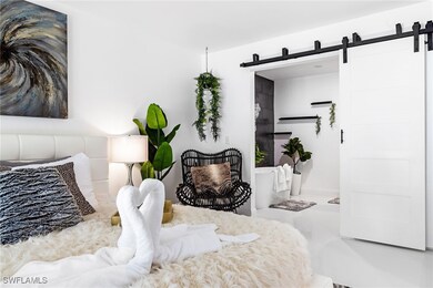 Bedroom featuring a barn door and tile floors