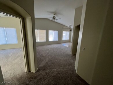 Hallway with carpet and lofted ceiling