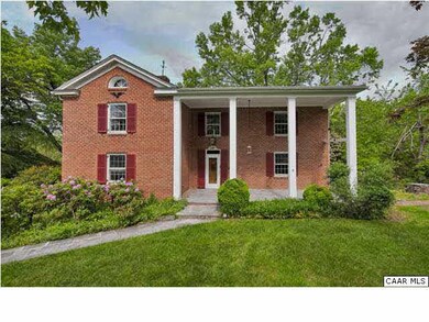 Classic two story colonial brick home with columns