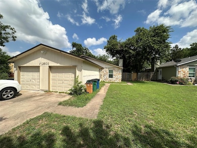 View of property exterior with driveway and stone