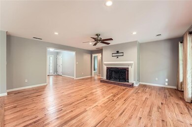 Unfurnished living room with recessed lighting, ceiling fan, baseboards, light wood-style floors, and a fireplace