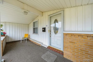 Entrance to property featuring board and batten siding