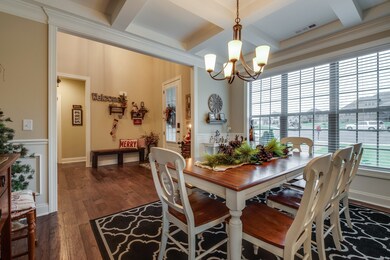 The coffered ceiling and wainscoting in the formal dining room will surely impress dinner guests!