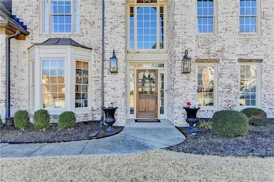 Doorway to property featuring brick siding
