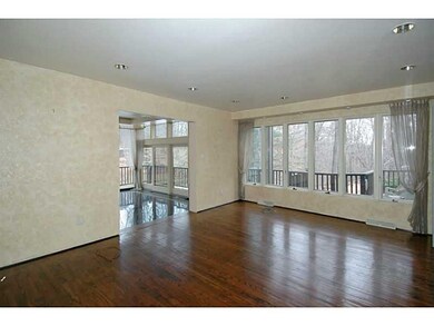 Living Room. Gleaming hardwood floors are located 