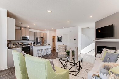 Family room, eat-in kitchen and fireplace  - Photos are of model home, colors and finishes may vary.