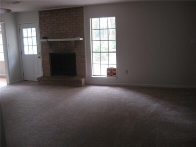 Den with fireplace- overlooks patio and yard