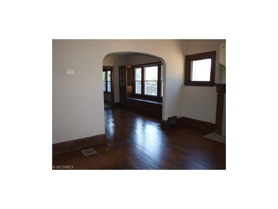 Down unit view from living room into dining room. Dining room has newer windows.