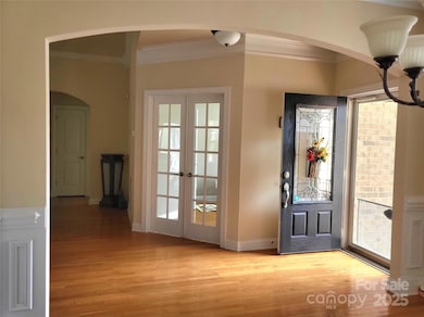 Foyer view and library entry with french doors