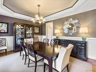 Dining room with tray ceiling and wainscoting
