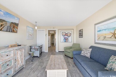 Living area with light wood-style flooring and baseboards