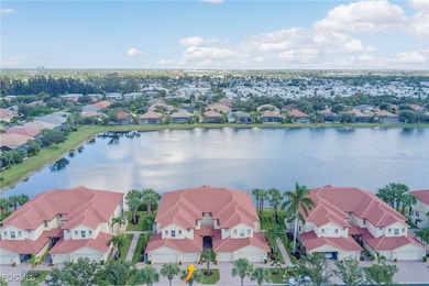Aerial perspective of suburban area featuring a nearby body of water