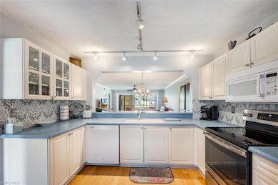 Kitchen featuring light wood-style flooring, a sin