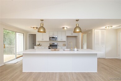 Kitchen with stainless steel appliances, a sink, w