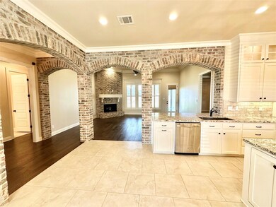 Kitchen with stainless steel dishwasher, a firepla