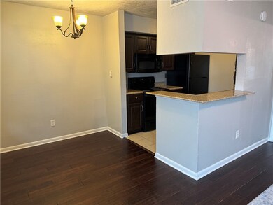 Kitchen with pendant lighting, black appliances, d