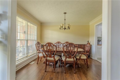 Dining room featuring a chandelier, crown molding,