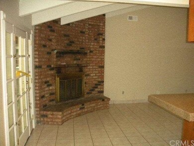 Family Room with Corner Fireplace and French Doors