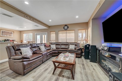 Living area with recessed lighting, french doors,