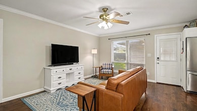 Another view of the living room showcasing the smooth flow into the kitchen and backyard access. A great space for relaxing, entertaining, or hosting gatherings.