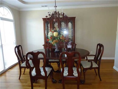 The large formal dining room has gleaming hardwood