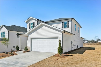 View of front of home featuring concrete driveway 
