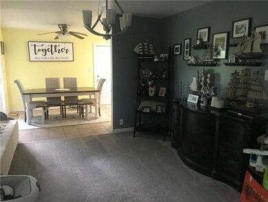 The dining room connects the living room with the 
