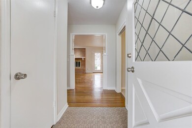 Hallway featuring light wood-type flooring and bas
