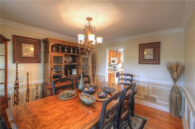 Formal Dining Room features custom trim, chair rai