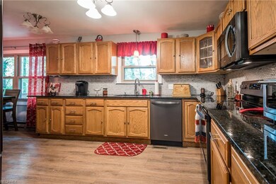 Well-design oak kitchen with granite countertops &