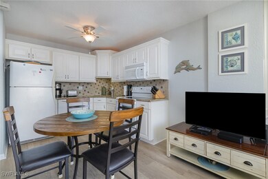 Kitchen with white cabinets, white appliances, and