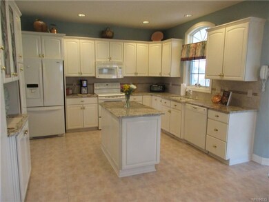 Large kitchen with granite tops, island expands wo