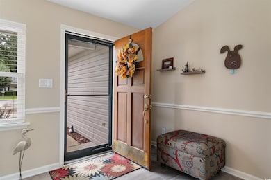 Entryway with wood finished floors and baseboards