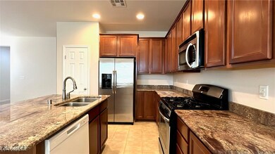 Kitchen featuring stainless steel appliances, dark
