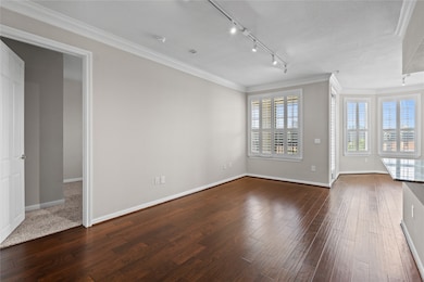 Open living area with hardwood floors and natural light