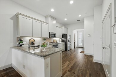 Kitchen with dark wood-type flooring, decorative b