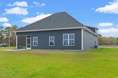 View of property exterior with a yard and central 