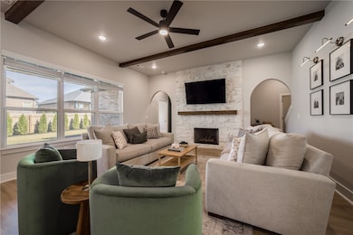 Beautiful custom stained beams and a limestone fireplace in the living room.
