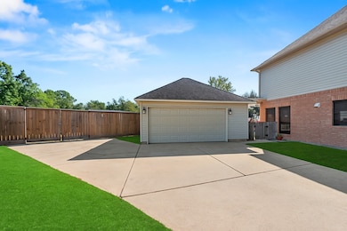 2-car detached garage with extra parking. Grass has been digitally enhanced to show potential.
