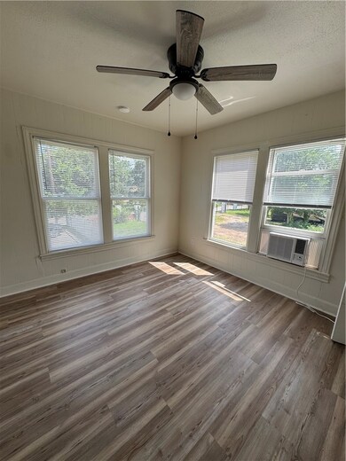 Unfurnished room with wood finished floors, a text