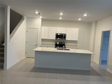 Spacious kitchen area with breakfast bar.