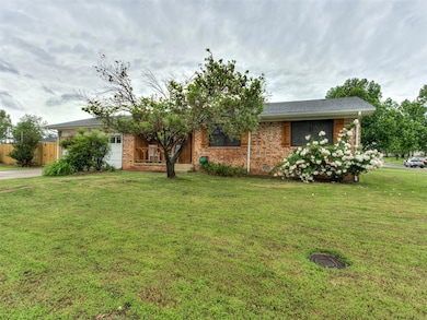 Ranch-style home featuring brick siding and concre