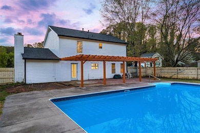 View of swimming pool with a fenced backyard, a fe