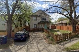 Traditional home with a fenced front yard