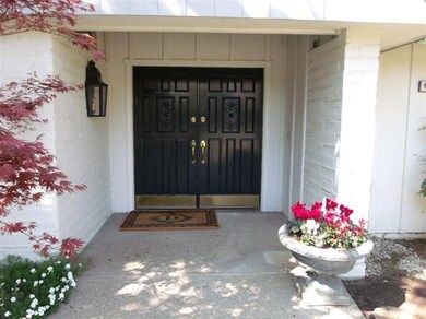Sheltered front porch with double door entry.