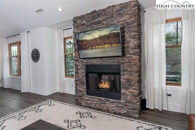 Spacious great room is light filled- 4 windows fla